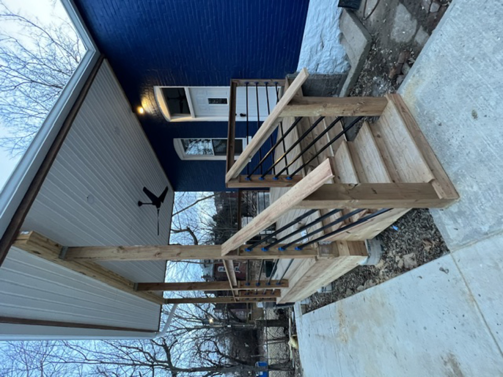 Completed exterior — new porch steps and cable railing