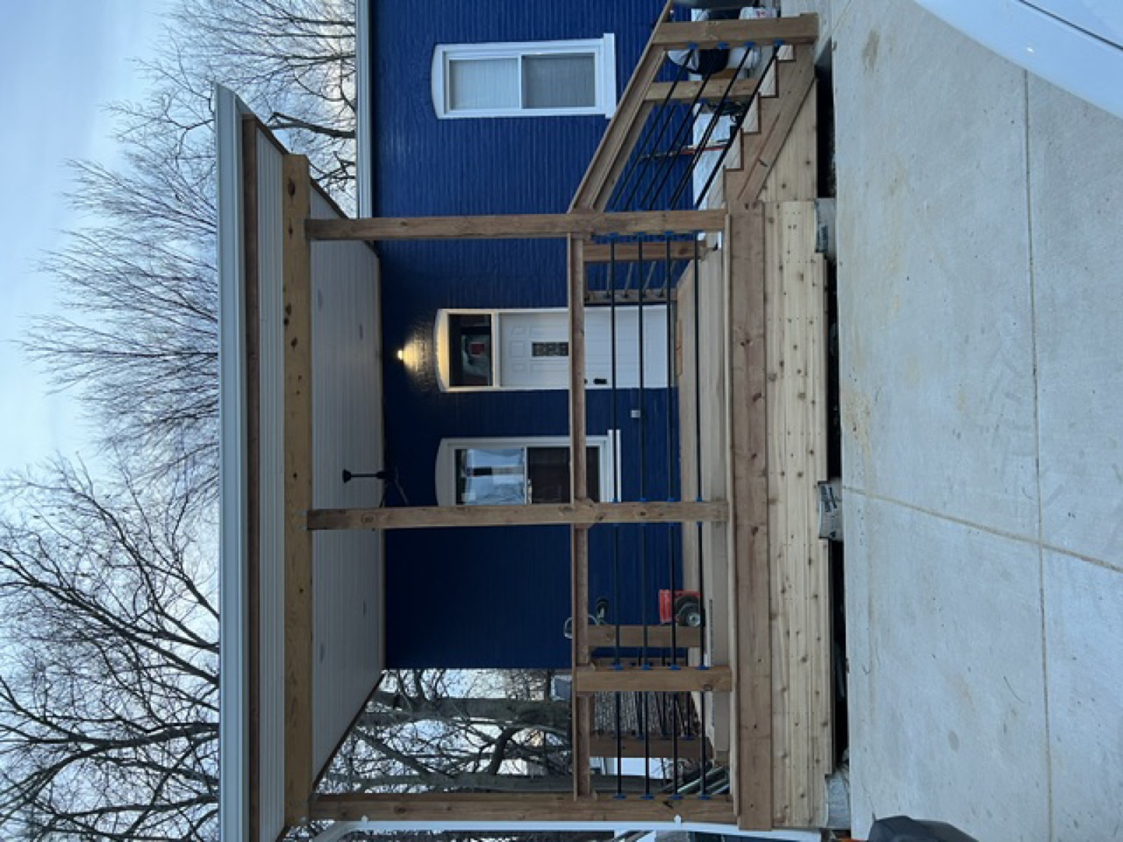 Fully renovated exterior — new porch, siding, and lighting