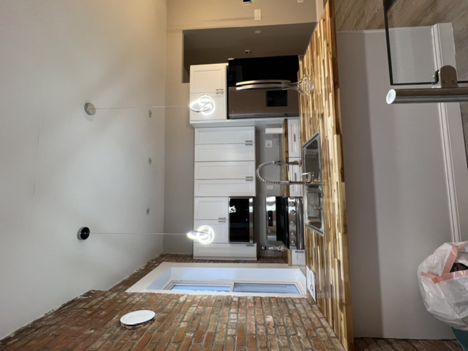 Modern kitchen with exposed brick, butcher block island
