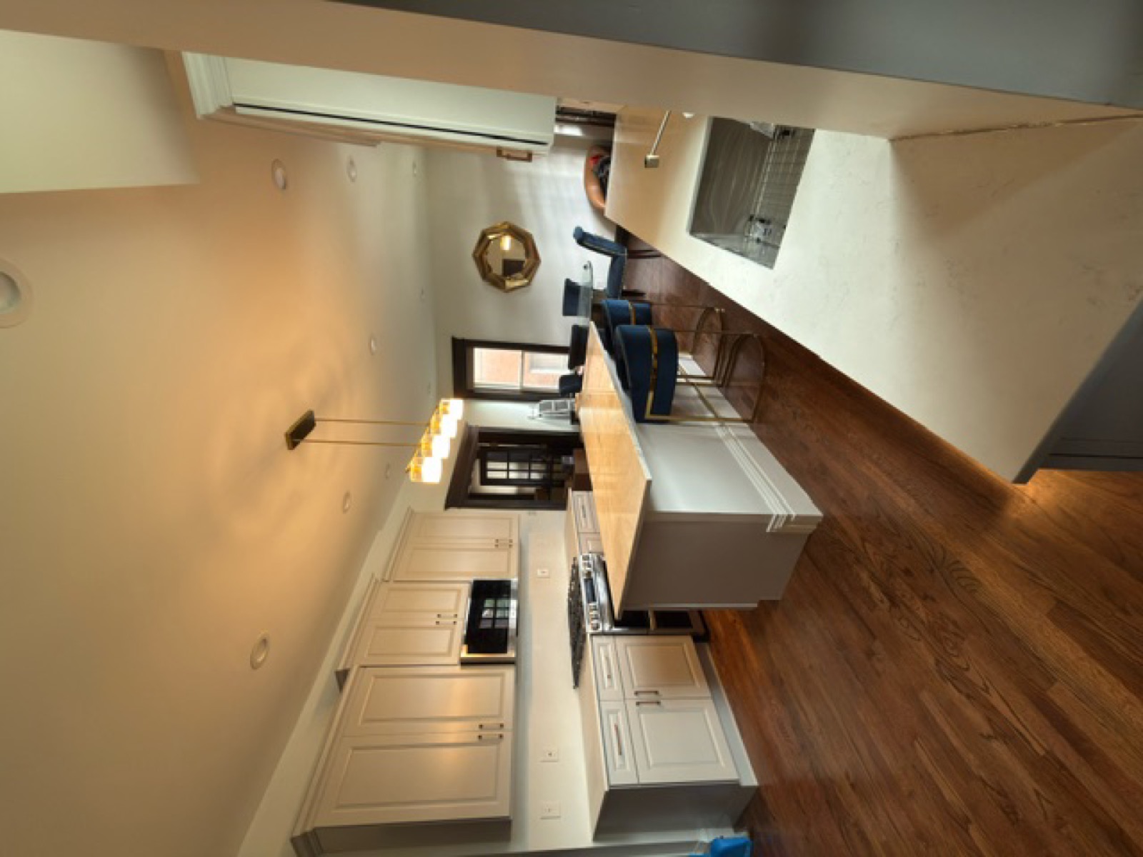 Full kitchen remodel — white shaker cabinets, marble island, blue bar stools