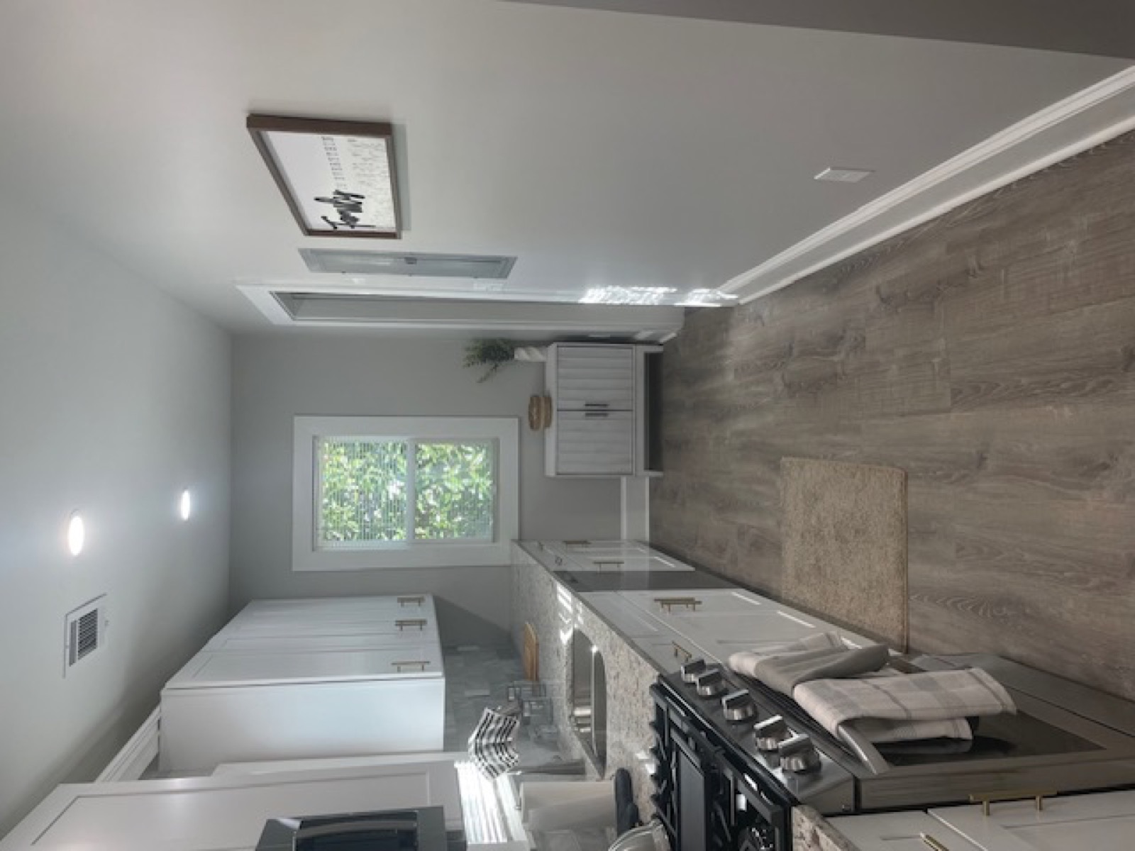 Finished kitchen — white cabinets, hardwood floors