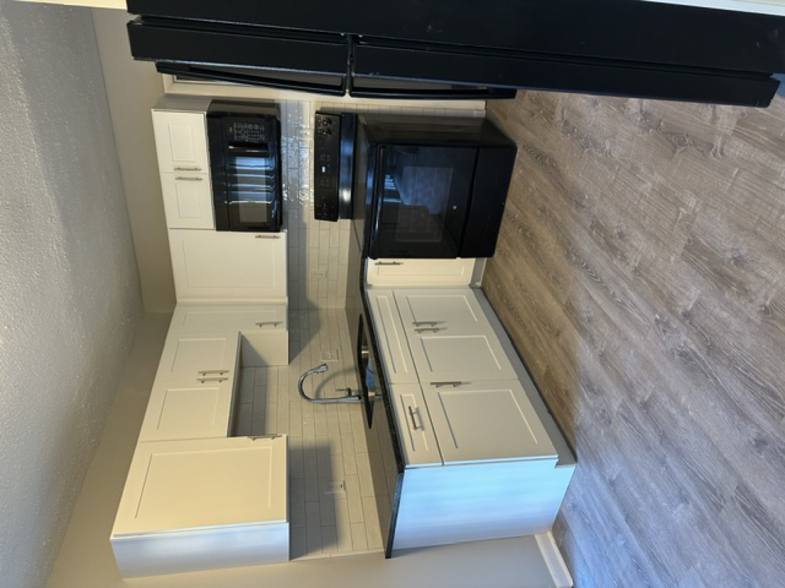 Kitchen renovation complete — white cabinets and appliances
