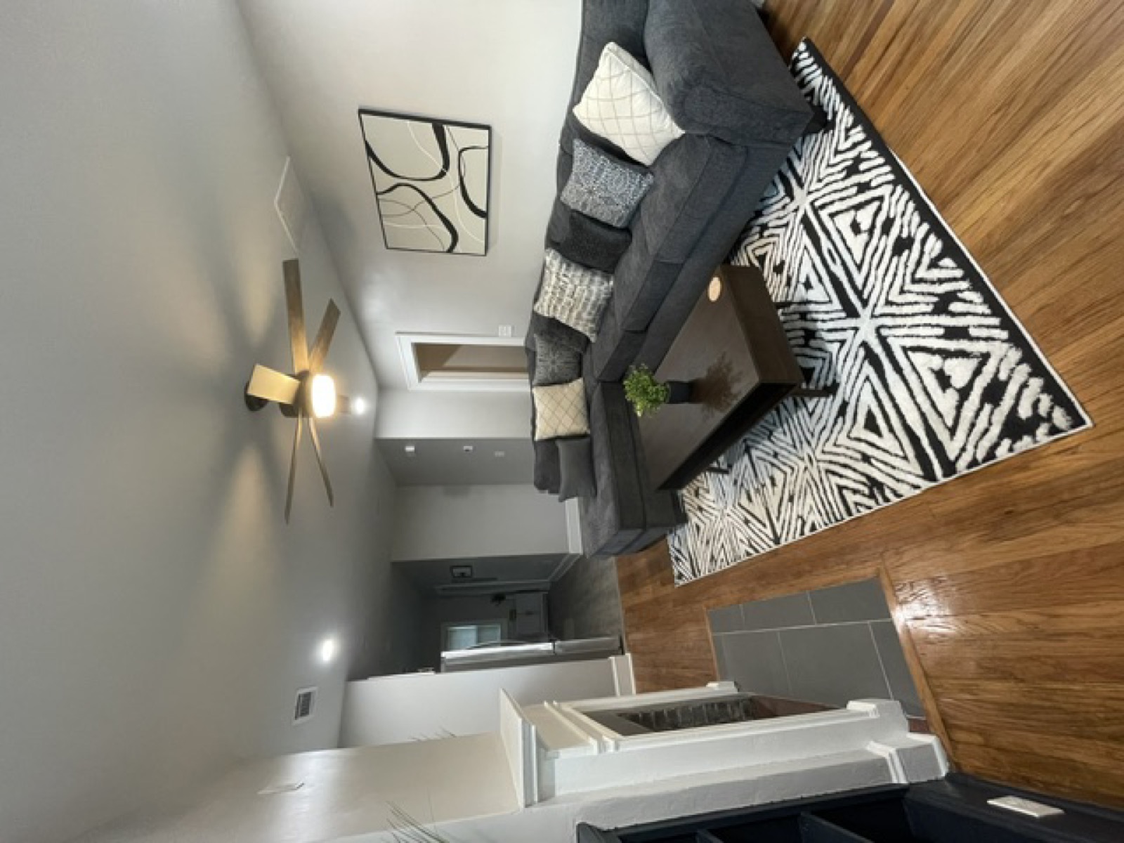 Finished living room — hardwood floors, fireplace, open plan